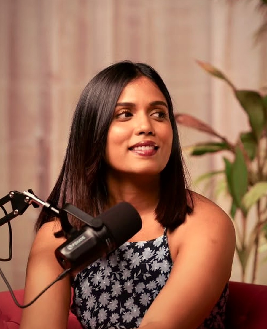 Raji, host of The Star Next Door, smiling during an interview